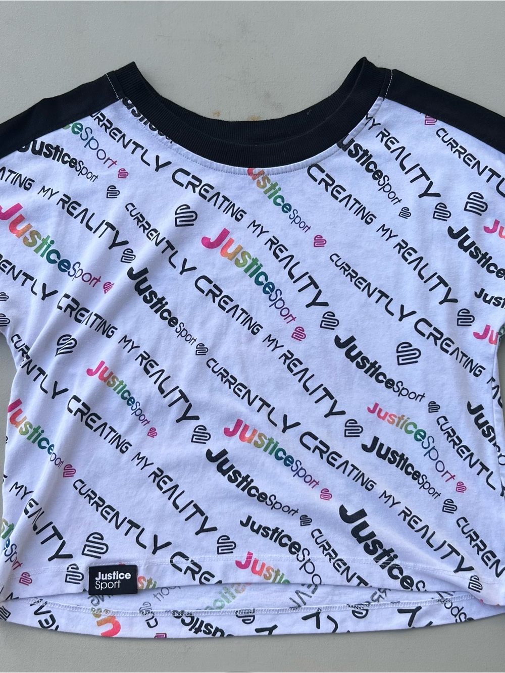 Justice White Tee with Black Trim and Multicolor Logo Print